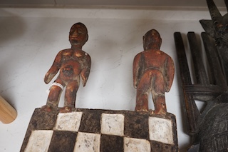 Three African tribal masks and a carved folding tray, largest 92cm. Condition - fair to good